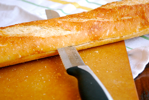 Slicing the Bread Homemade Garlic Bread recipe and images by Lacey Baier, a sweet pea chef