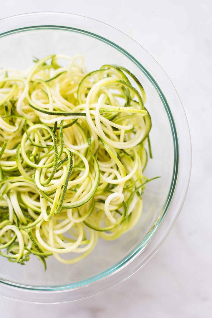 Bowl of spiralized zucchini noodles, ready to be added to the skillet and cooked in order to make the healthy shrimp scampi recipe.