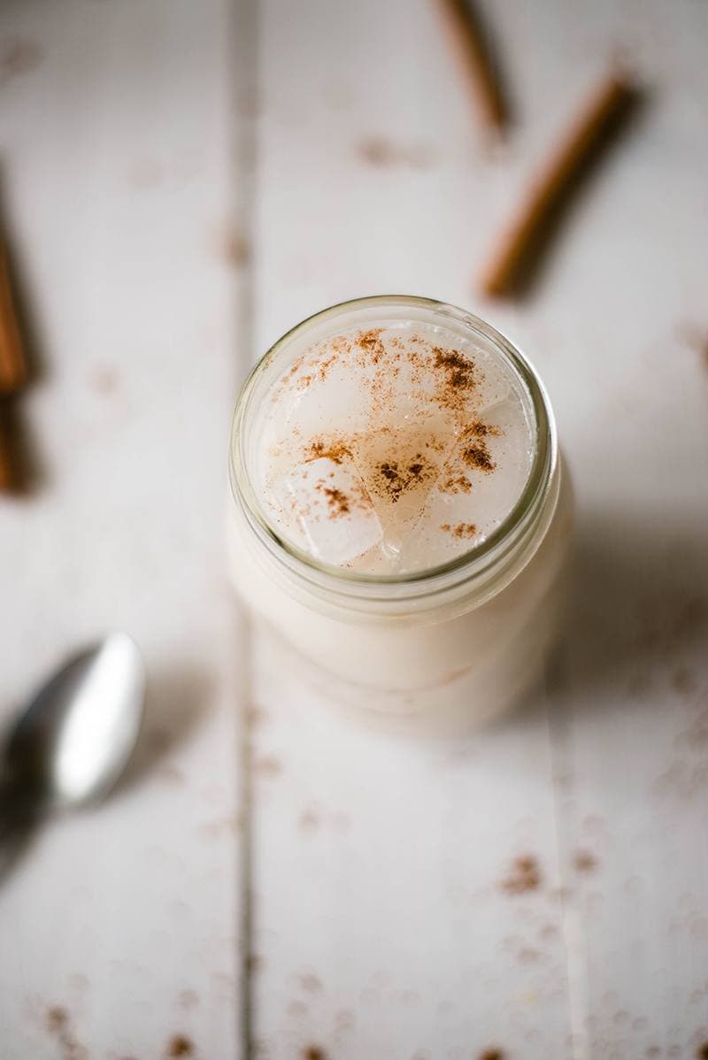 Close up photo of Mexican Horchata drink served with ice cubes and garnished with cinnamon 