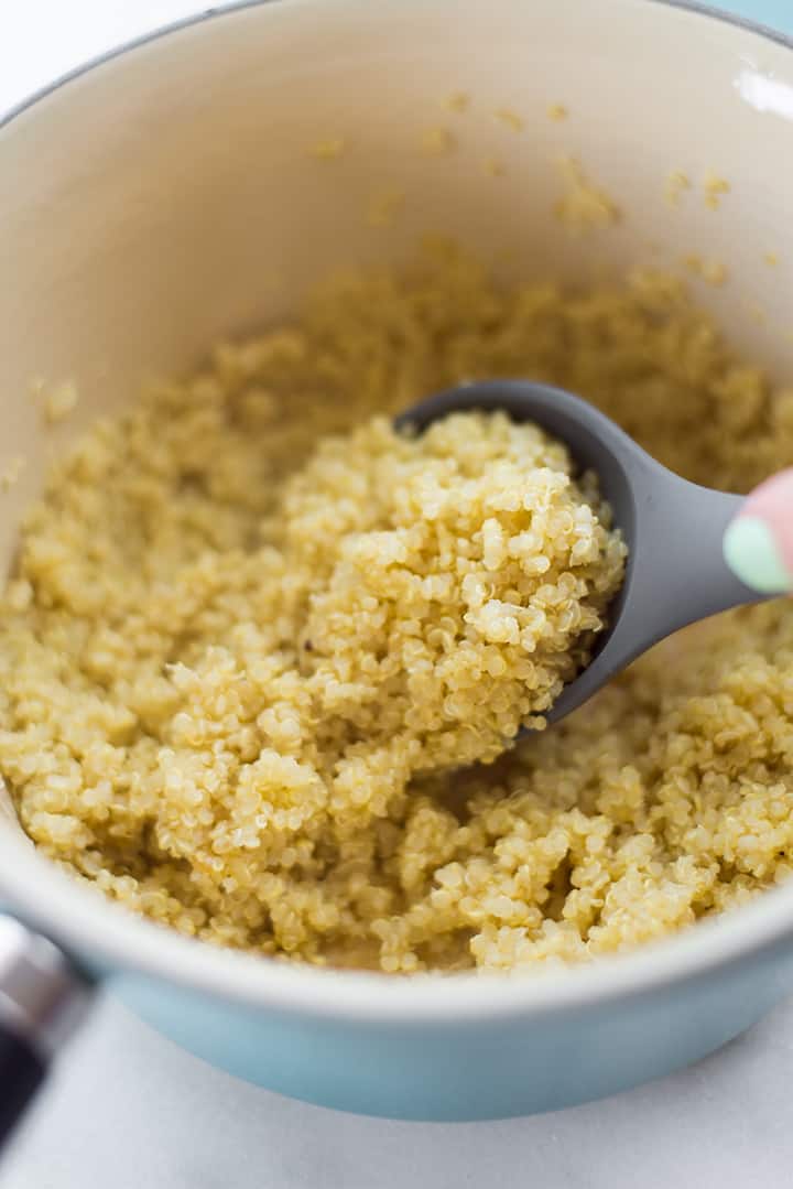 Close-up of cooked quinoa in a sauce pan, ready to be added to the summer corn edamame salad.