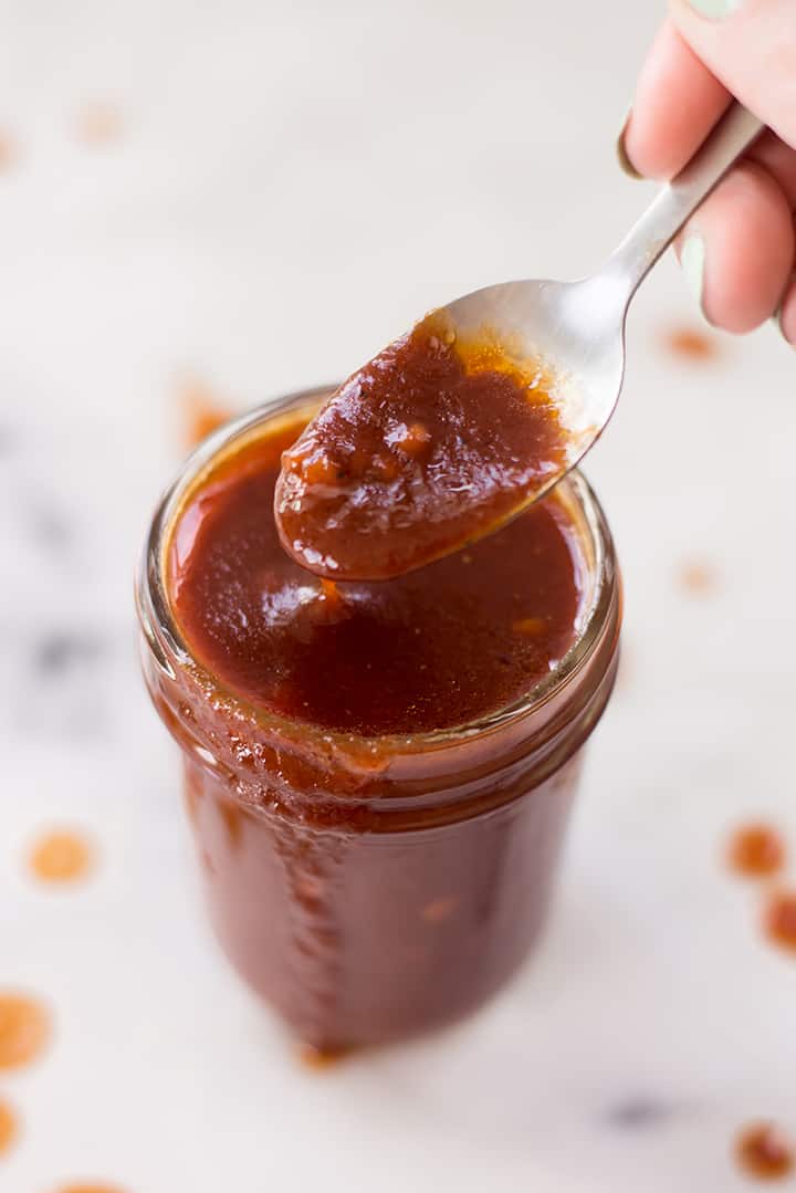 Spoon up close showing the texture of the sweet bbq sauce.