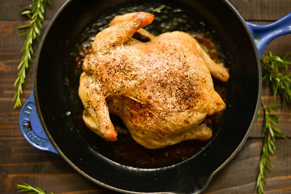 Overhead image of the Healthy Oven Roasted chicken in the oven-proof skillet, ready to cool and slice.