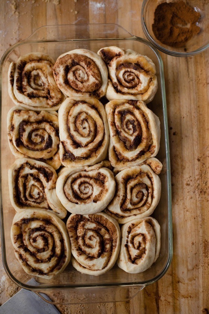 Overview of 12 Homemade Healthy Cinnamon Rolls placed in a glass dish and ready to bake.