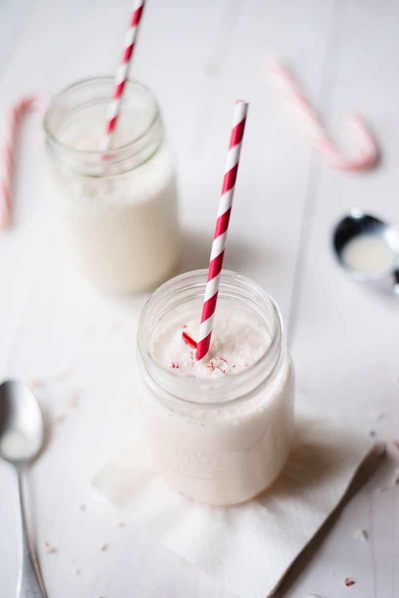 Overhead view of two mason jars filled with Peppermint Milkshake, a dairy item.