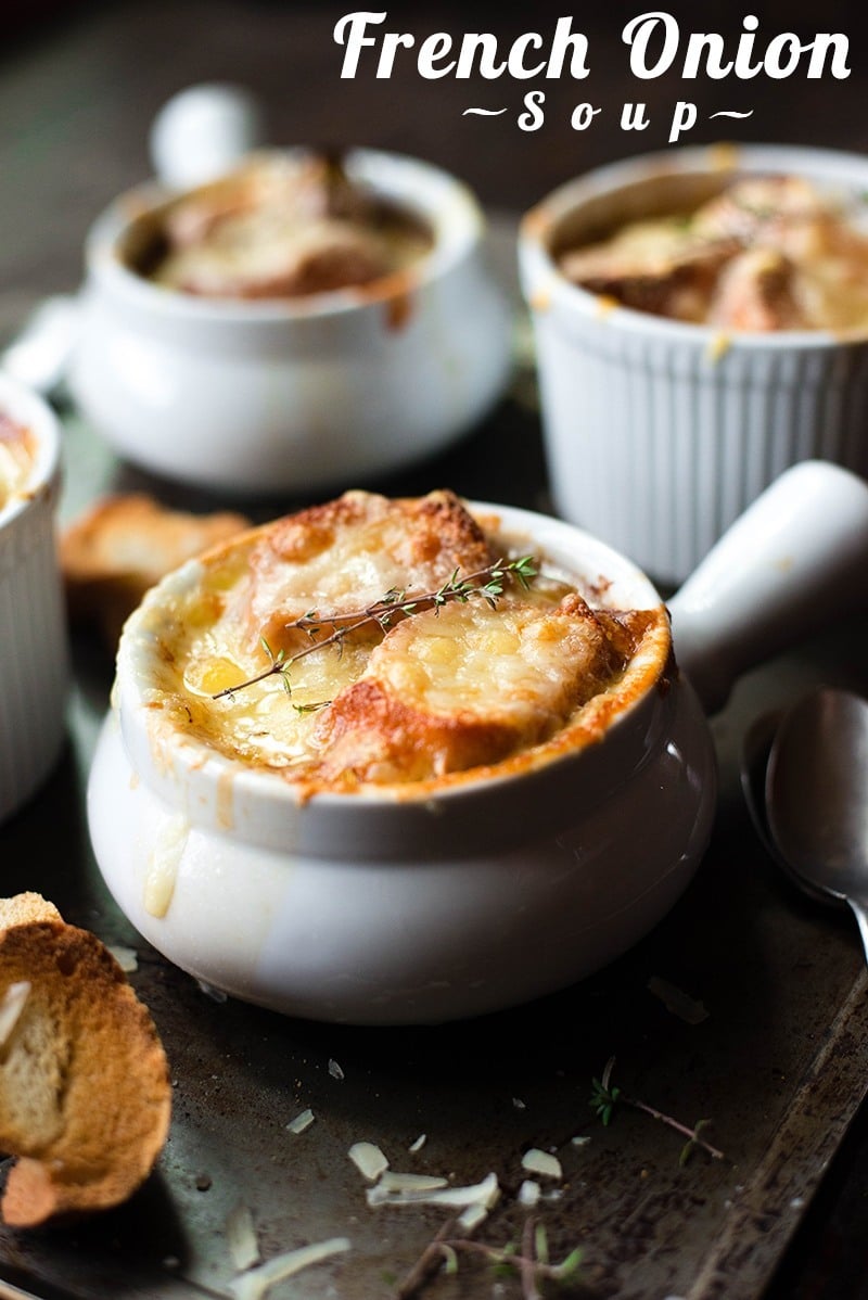 Close up view of 3 oven-proof white bowls filled with ready to serve, baked French Onion Soup