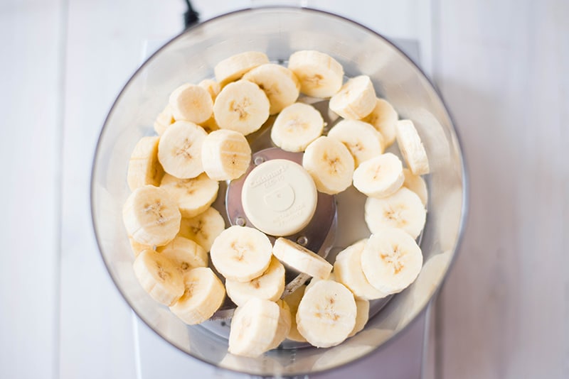 Frozen banana slices in a blender, ready to be pulsed to make banana ice cream recipe 