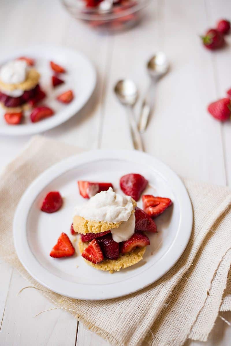 Close up of strawberry almond flour shortcake resting on a serving plate, ready to be enjoyed 