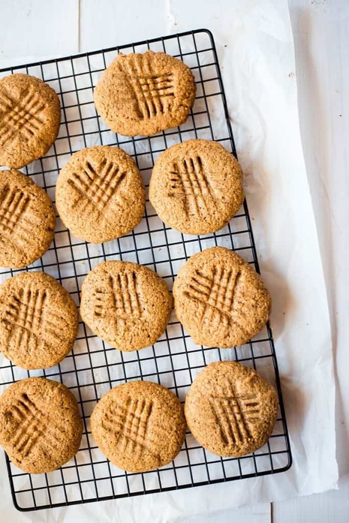 Close up image of a cooling rack of baked cookies made with protein powder as an ingredient.
