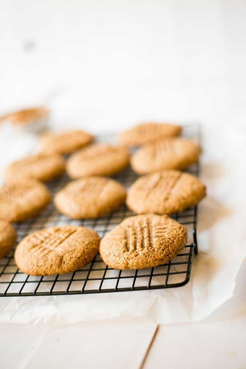 The peanut butter protein cookies have been baked and are cooling on a cooling rack.