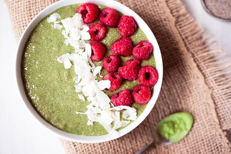 Overhead view of Matcha Chia Pudding, made with healthy matcha tea, topped with raspberries.
