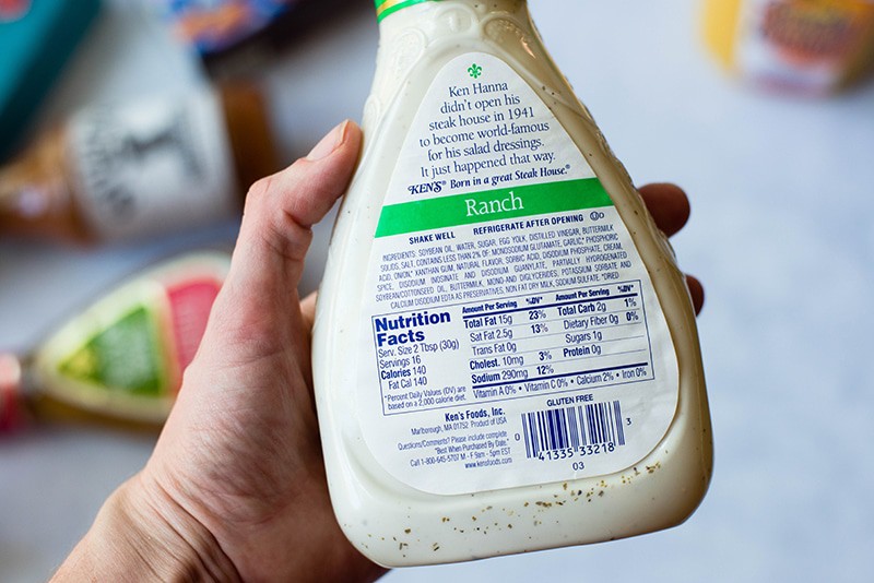 Close up view of the label on the back of a salad dressing jar, showing the sugar content as an added sugar product.