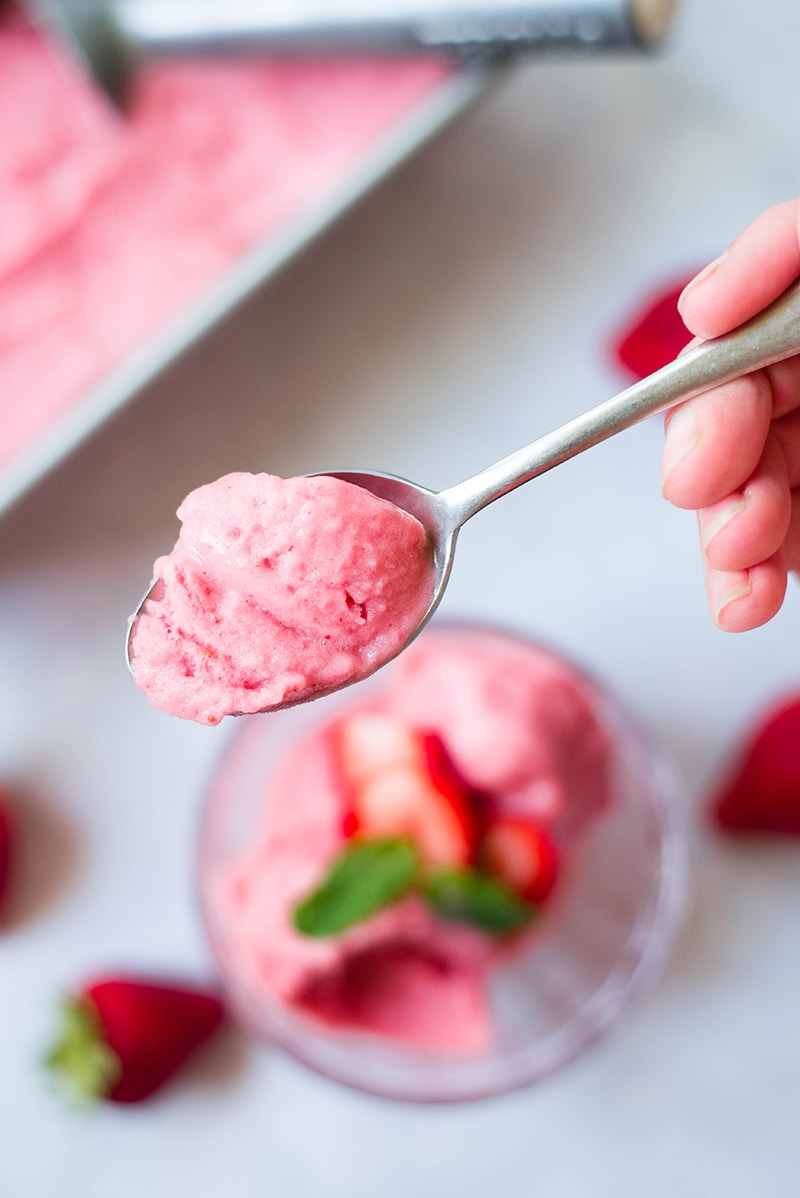 Close up photo of a spoonful of strawberry frozen yogurt 