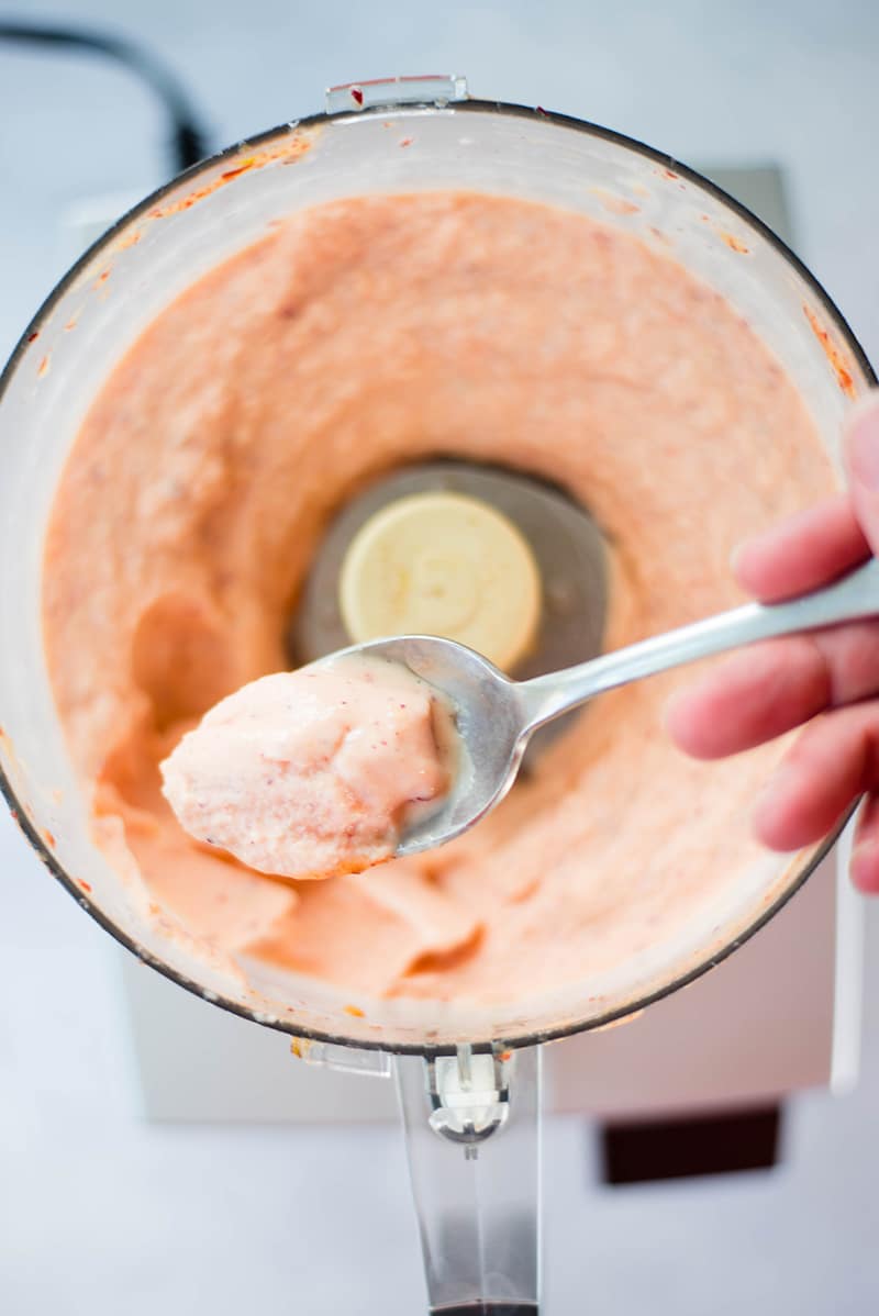 Spoonful of peach frozen yogurt made with a food processor, and ready to be served 