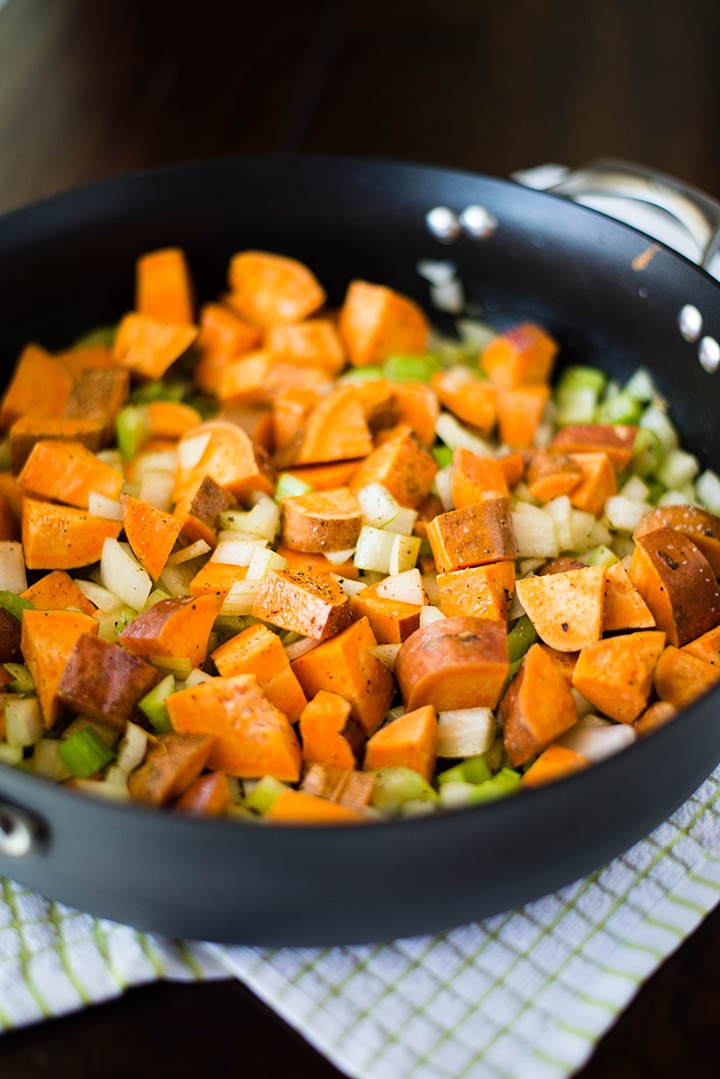 Large skillet with cooked sweet potato hash, ready to serve.