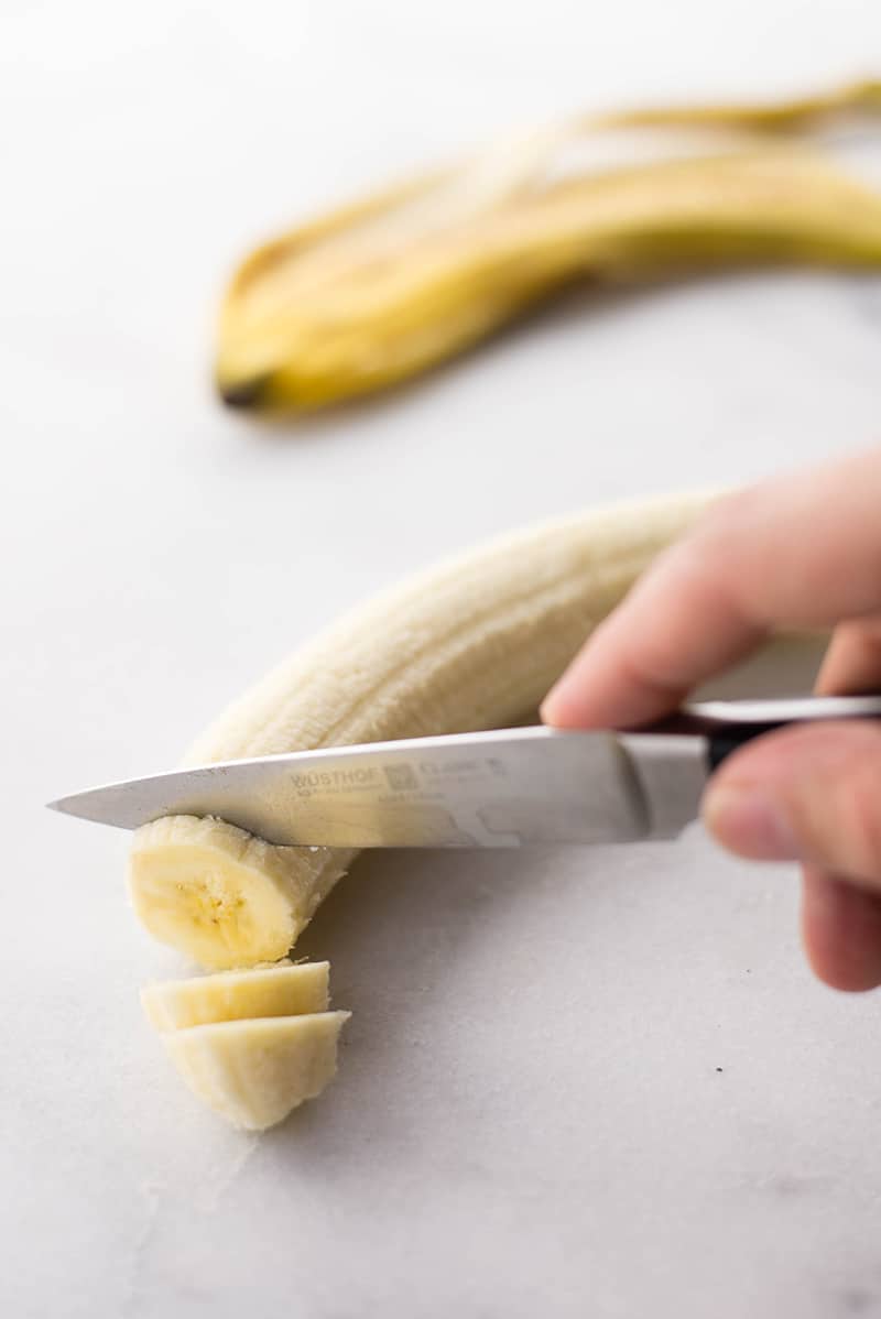 : A banana peeled and sliced to make chocolate and banana ice cream 