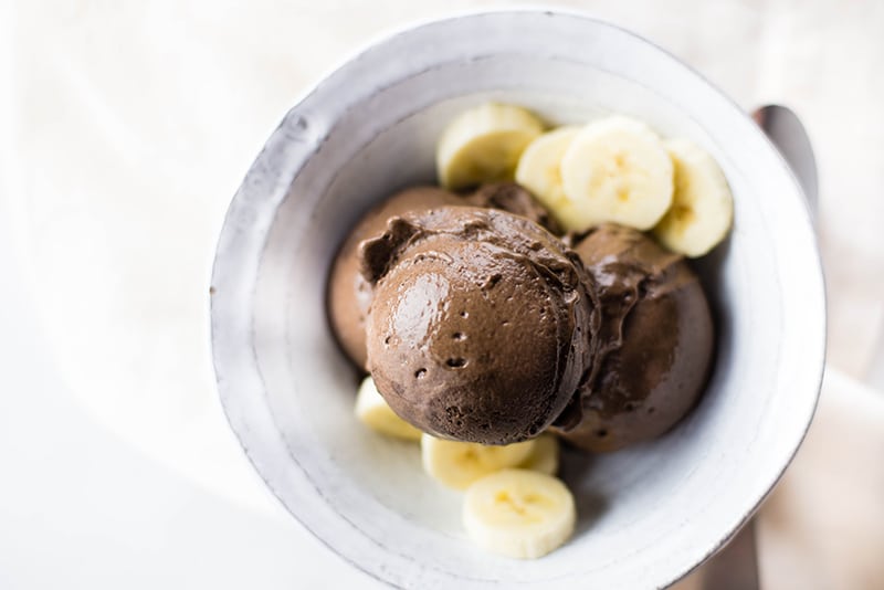 Bowl of chocolate banana ice cream, served with fresh banana slices 