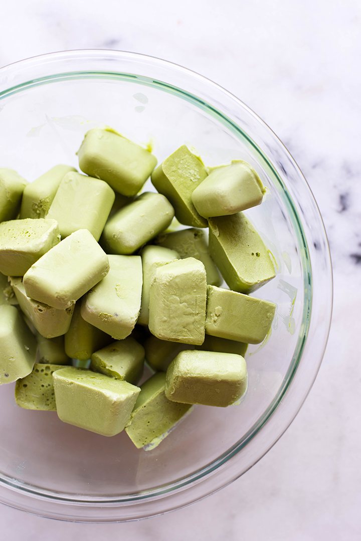 : Frozen yogurt cubes made with green tea Matcha ingredients, placed in a glass bowl 