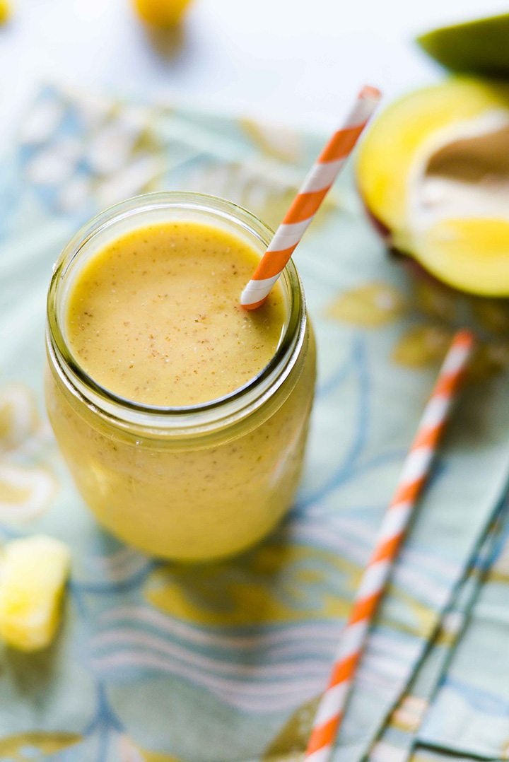 Overhead image of a High Protein Fruit Smoothie in a mason jar, which contains mango and chia seeds.