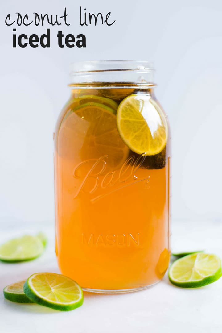 Quart size mason jar with lime slices and coconut water, ready to drink.
