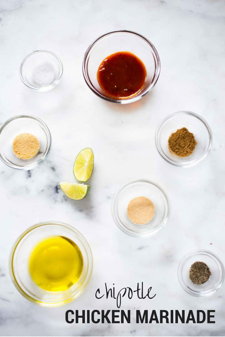 Ingredients separated for chipotle chicken marinade, including adobo sauce, cumin, onion powder, garlic powder, sea salt, pepper, lime juice, and olive oil.