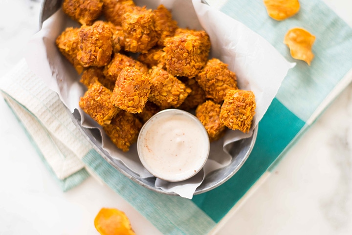 Close up shot of the baked sweet potato tots and greek yogurt dip, baked and ready to eat.