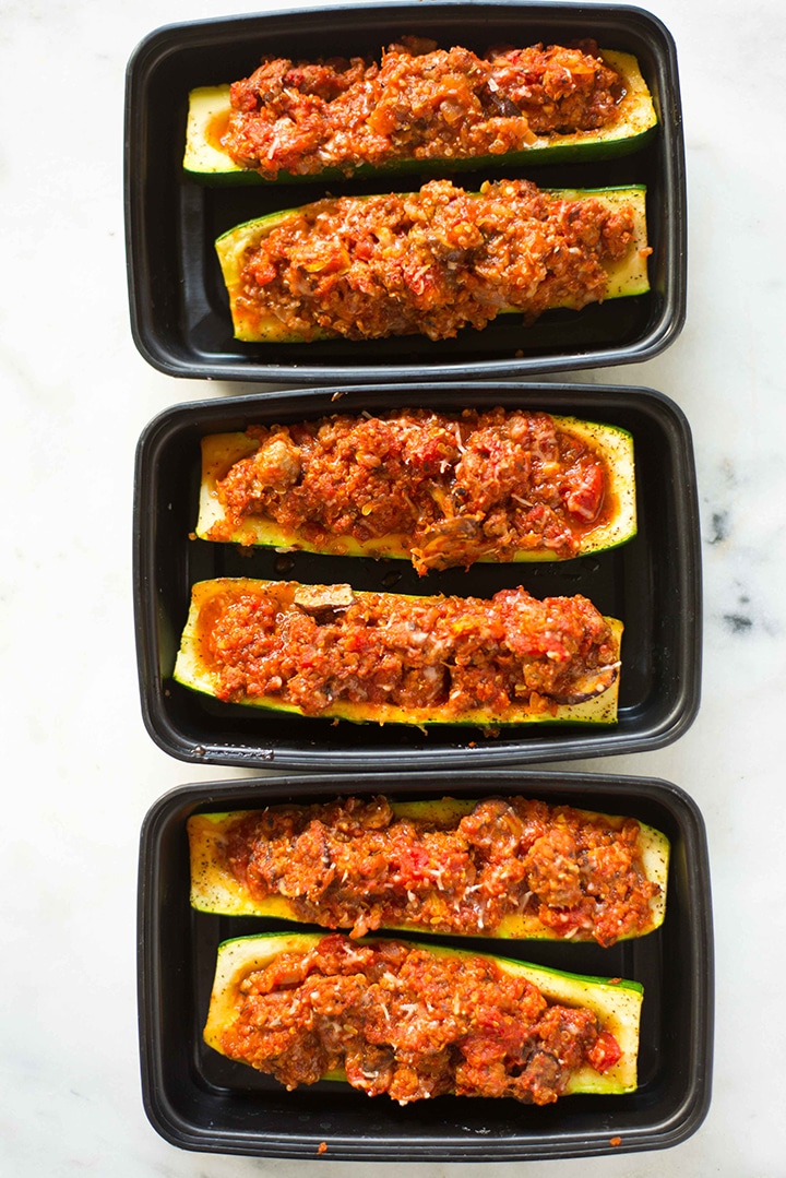 Image of three meal prep containers filled with two zucchini boats each, rady to store and have ready to grab during the week.