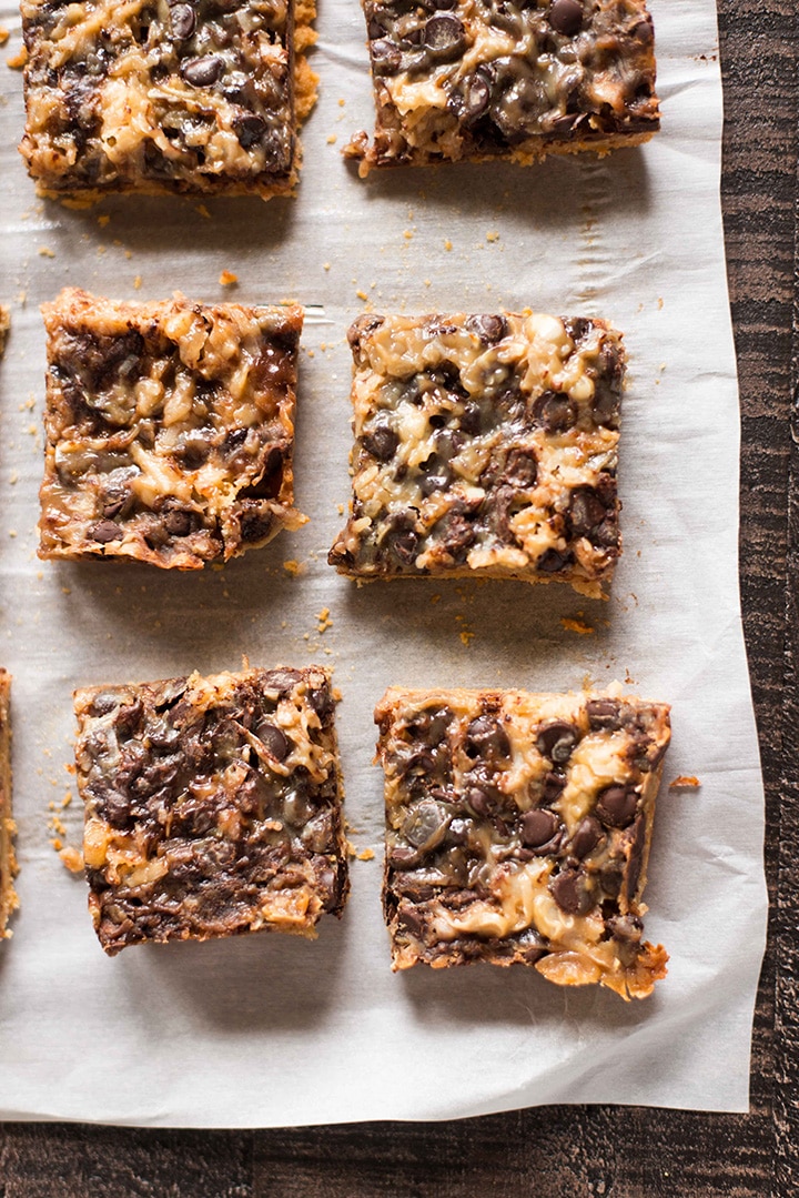Vertical image overhead of 6 paleo 7 layer bars that are cooling from the oven and have been divided into squares.
