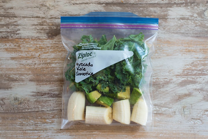 Smoothie freezer pack of avocado kale smoothie in ziplock bag, ready to be frozen.
