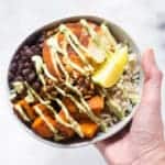 This High Protein Chicken Bowl is a nutrient-packed dish, including spicy chicken, savory sweet potatoes, black beans, and toasted pumpkin seeds. It's drizzled with a cashew lime crema and will soon become one of your favorite go-to dishes for extra protein.
