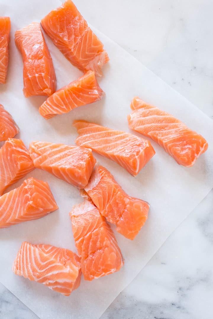 Fresh salmon filet cut into large strips to make the salmon fish sticks.