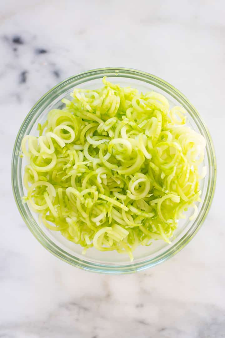 Bowl filled with spiralized broccoli stem noodles to show spiralizer veggie recipe.