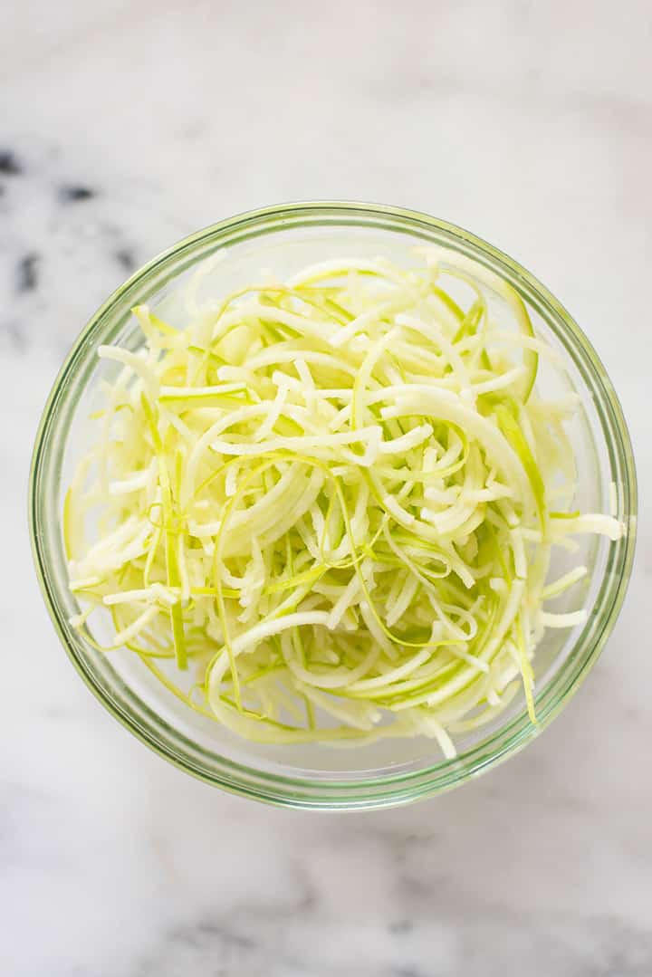 Bowl filled with spiralized apple noodles to show spiralizer veggie recipe.