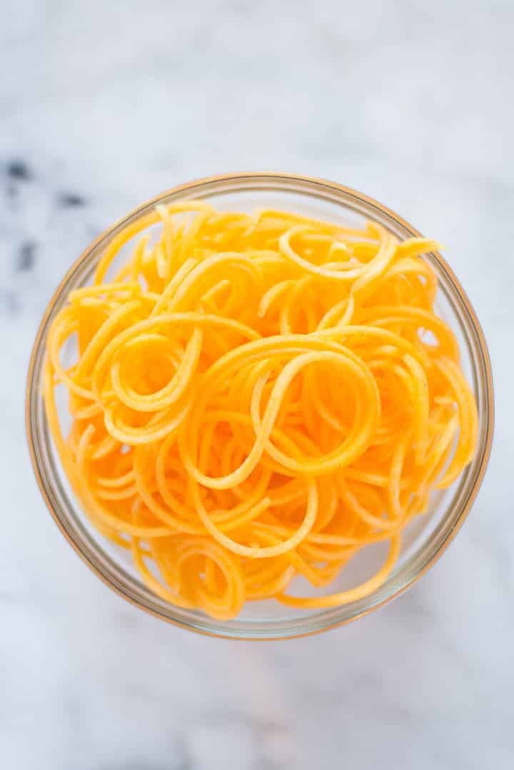 Bowl filled with spiralized butternut squash noodles to show spiralizer veggie recipe.