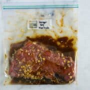 Sealable freezer bag with skirt steak and the Ginger Soy Marinade, marinating and ready to cook.