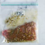 Sealable freezer bag with steak and the Garlic & Herb Marinade, marinating and ready to cook.