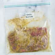 Sealable freezer bag with skirt steak and the Italian Marinade, marinating and ready to cook.