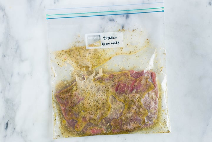 Sealable freezer bag with skirt steak and the Italian Marinade, marinating and ready to cook.