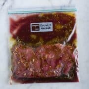 Sealable freezer bag with skirt steak and Red Wine Marinade, marinating and ready to cook.