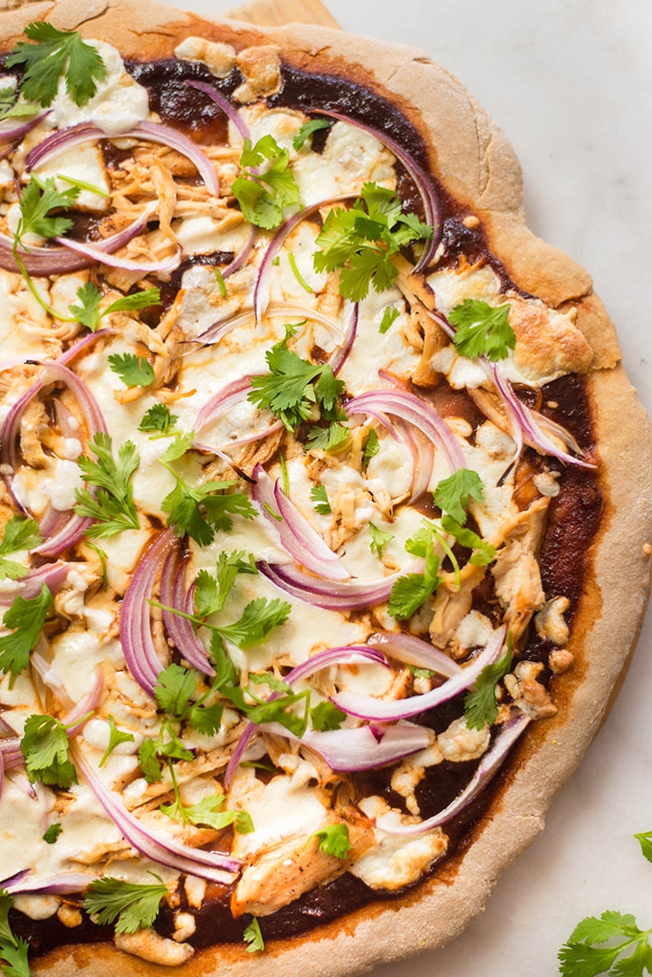 Overhead view of the best bbq chicken pizza which is now baked and topped with fresh cilantro.
