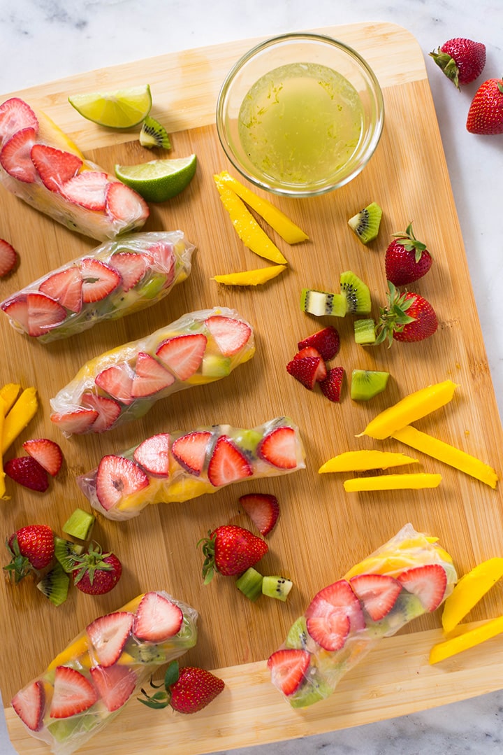 These fruity Kiwi Strawberry Spring Rolls are a burst of flavor and are super addicting, especially when dipped into the Honey Lime Sauce. A perfect summer dessert! One of the five healthy spring roll recipes.