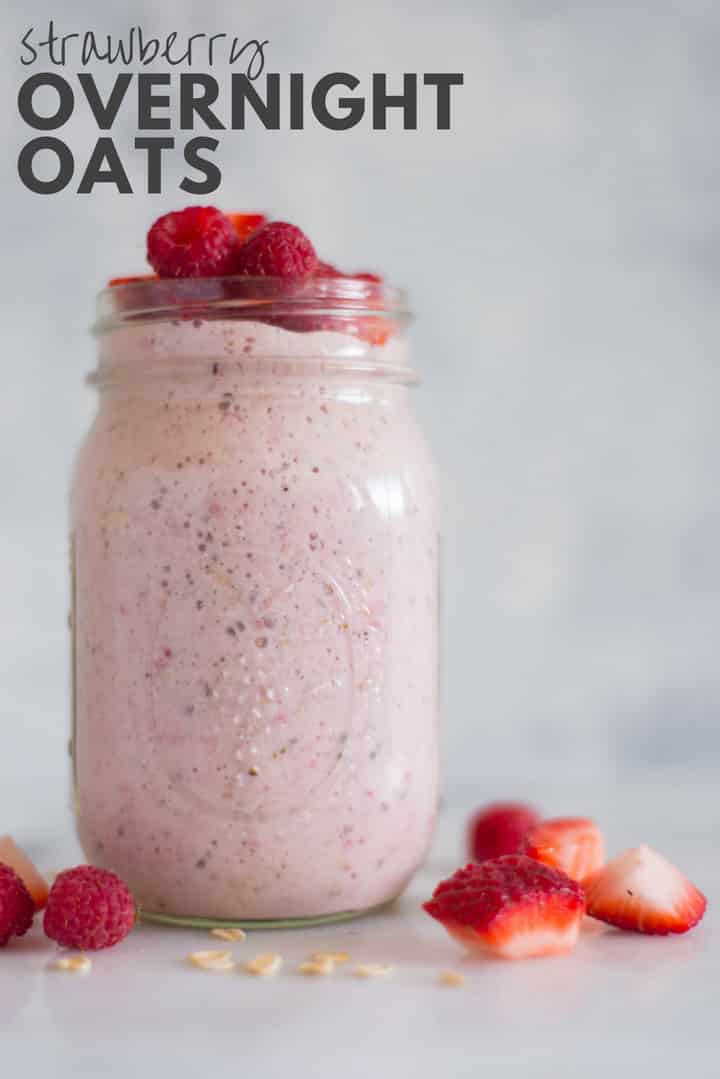 Horizontal view of a jar with Strawberry Overnight Oats with rolled oats, chopped strawberries, raspberries, chia seeds, pure maple syrup, vanilla, plain greek yogurt and almond milk, topped with sliced strawberries