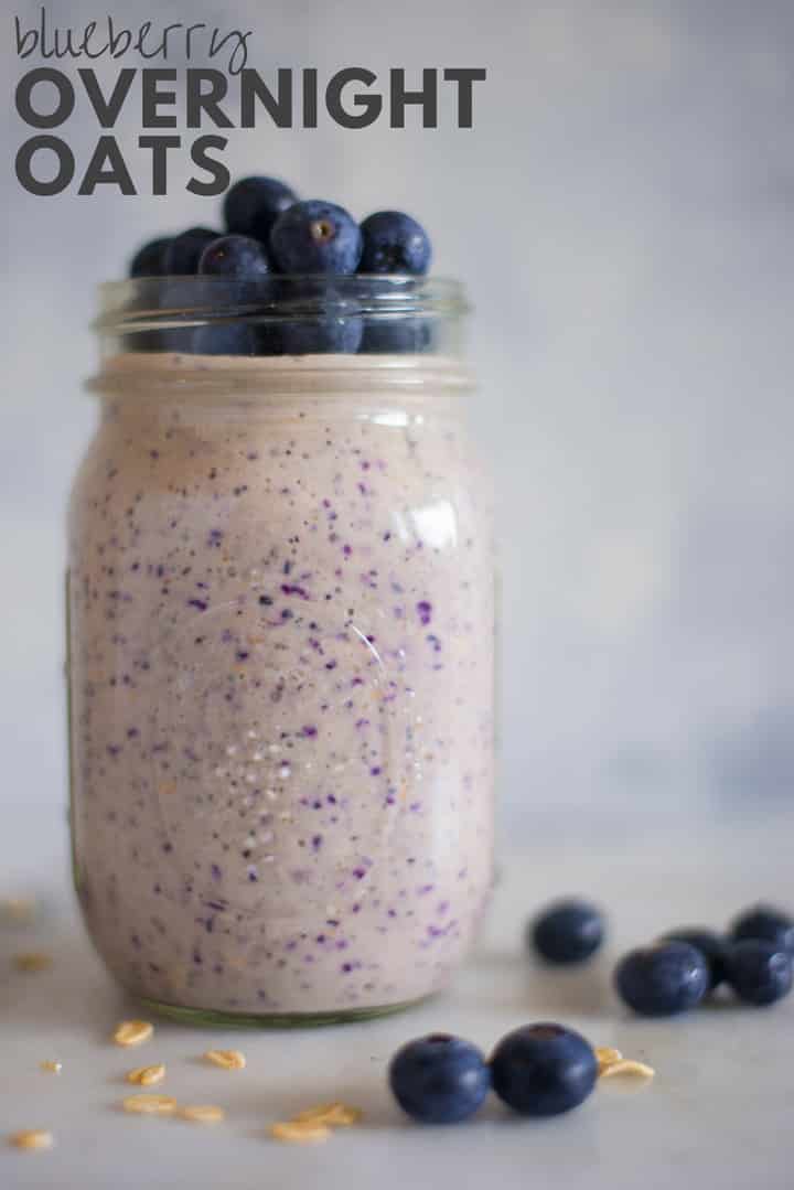Horizontal view of a jar with Blueberry Overnight Oats with rolled oats, blueberries, lemon zest, chia seeds, pure maple syrup, vanilla, plain greek yogurt and almond milk, topped with fresh blueberries