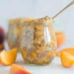 A side image of a glass jar filled with Homemade Peach Chia Jam made from fresh peaches, chia seeds, and raw honey.