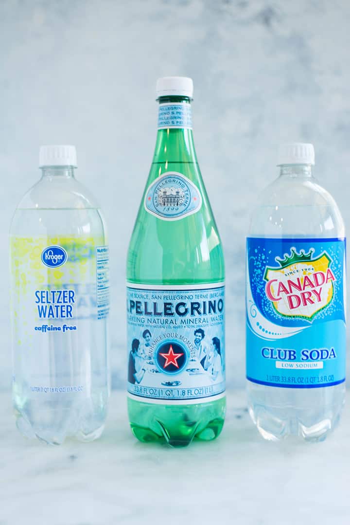 A side image of bottles of carbonated water you can use to make Caffeine-free Homemade Soda including Seltzer Water, Sparkling Mineral Water and Club Soda.