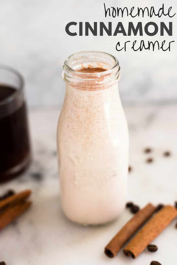An image of a glass bottle filled with healthy Homemade Cinnamon Creamer made with homemade condensed milk, almond milk, vanilla extract, pure maple syrup, arrowroot starch and cinnamon.
