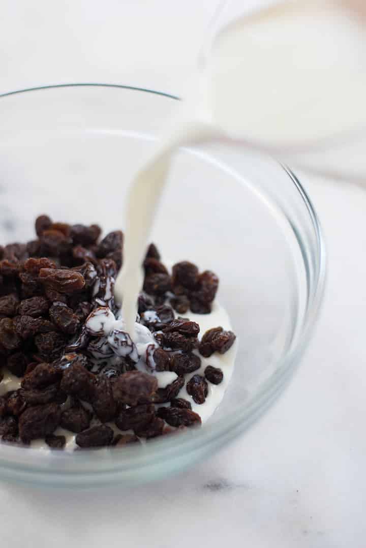 A side image of milk being poured over raisins to make condensed milk for the Healthy Coffee Creamer.