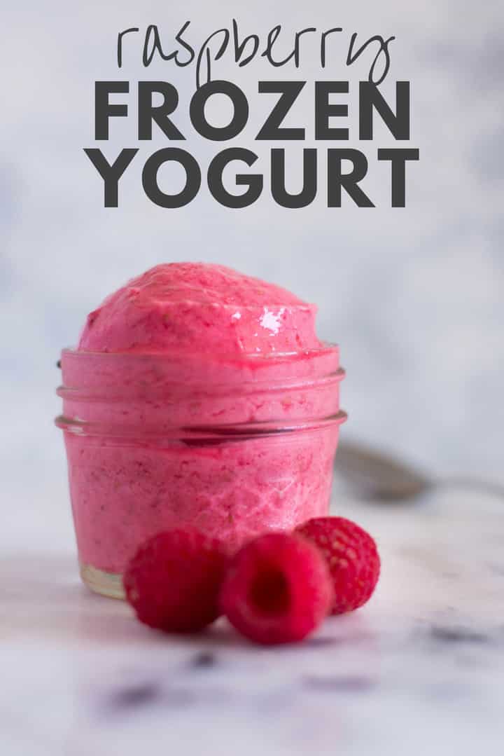 A side image of a serving of Raspberry Frozen Yogurt in a glass dessert bowl, made with fresh raspberries, full fat greek yogurt and raw honey.