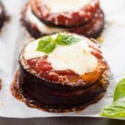 A close up image of Baked Eggplant Parmesan, made with roasted eggplant, homemade tomato sauce, mozzarella and grated parmesan, before placing it in the oven.