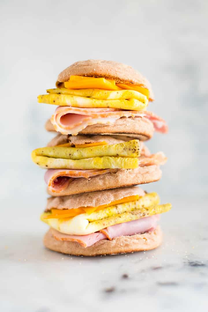 A tower made of 3 Make-Ahead Freezer Breakfast Sandwiches place on top of each other.