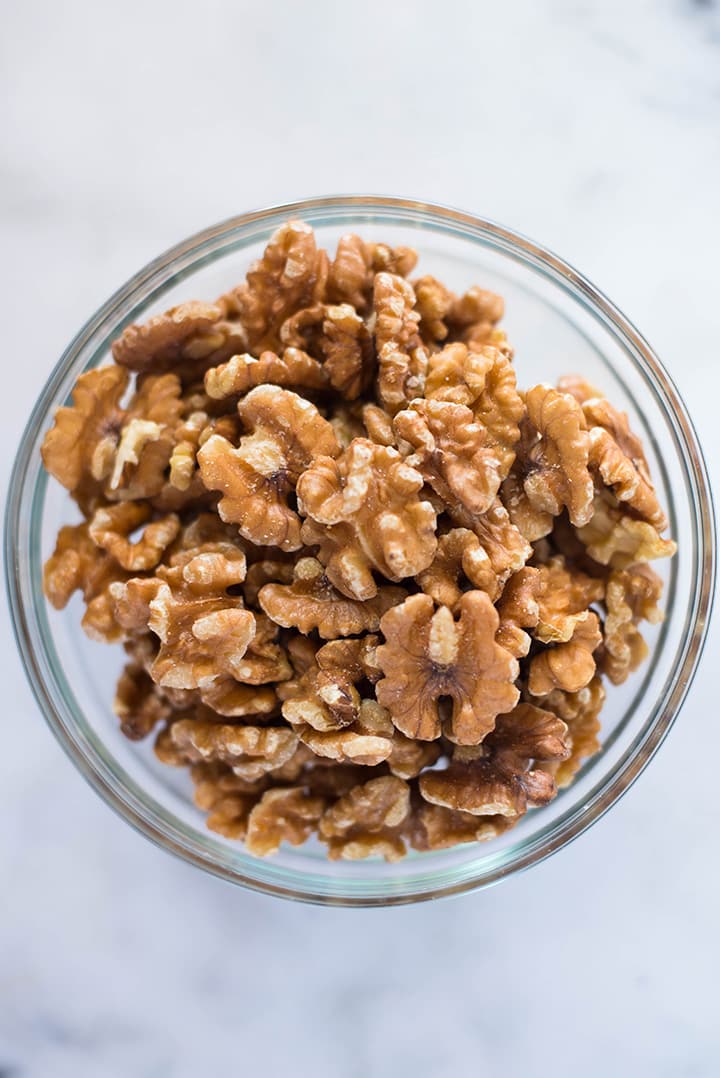 A bowl of raw walnuts that will be used to make Healthy Banana Nut Bread.